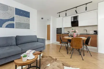a living room with a couch and a table at Zbożowa 2A Apartments Nowy Kleparz Cracow by Noclegi Renters in Kraków