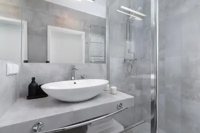 a bathroom with a white sink and a shower at City center studio with a balcony - Rajska 3 in Kraków