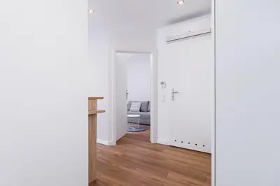 a hallway with a door leading into a living room at Kazimierz District - Orzeszkowej 6 Street in Kraków