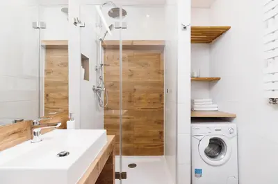 a bathroom with a sink and a washing machine at Kazimierz District - Orzeszkowej 6 Street in Kraków