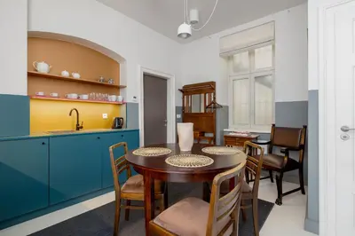 a kitchen and dining room with a table and chairs at Św Jana Street - Main Square Apartment in Kraków