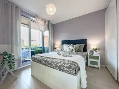 a bedroom with a large bed and a large window at Nadwiślańska Przystań Apartament z widokiem na Wisłę in Kraków