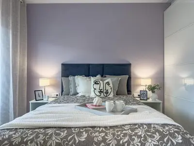 a bedroom with a bed with a tray of food on it at Nadwiślańska Przystań Apartament z widokiem na Wisłę in Kraków