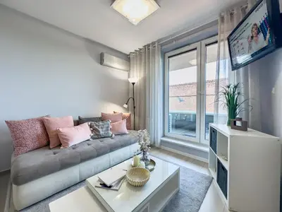 a living room with a couch and a large window at Nadwiślańska Przystań Apartament z widokiem na Wisłę in Kraków