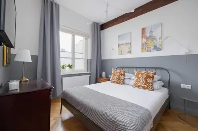 a bedroom with a bed and a window at 2 bedroom apartment Św Jana - Main Square in Kraków