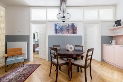 a dining room with a table and chairs at 2 bedroom apartment Św Jana - Main Square in Kraków