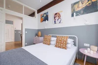 a bedroom with a white bed and a table at 2 bedroom apartment Św Jana - Main Square in Kraków