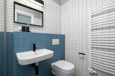 a blue and white bathroom with a sink and a toilet at 2 bedroom apartment Św Jana - Main Square in Kraków