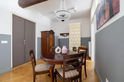 a dining room with a table and chairs at 2 bedroom apartment Św Jana - Main Square in Kraków