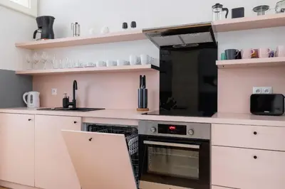 a kitchen with white cabinets and an oven at 2 bedroom apartment Św Jana - Main Square in Kraków
