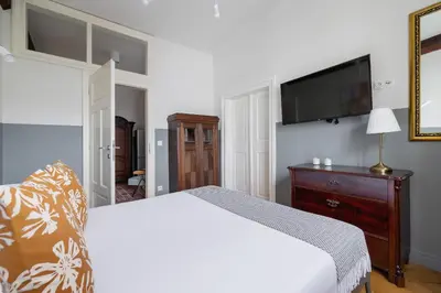 a bedroom with a bed and a flat screen tv at 2 bedroom apartment Św Jana - Main Square in Kraków