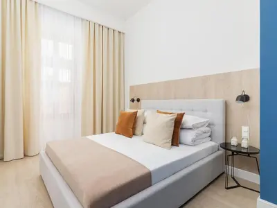 a bedroom with a large white bed with pillows at 4 Bedroom Apartment - Main Square in Kraków