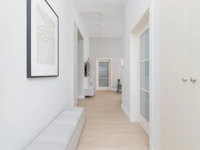 a hallway with white walls and a wooden floor at 4 Bedroom Apartment - Main Square in Kraków