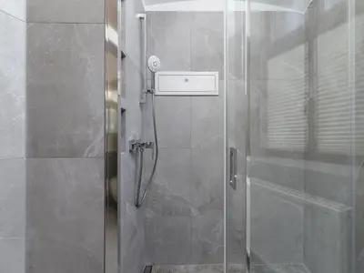 a shower with a glass door in a bathroom at 4 Bedroom Apartment - Main Square in Kraków