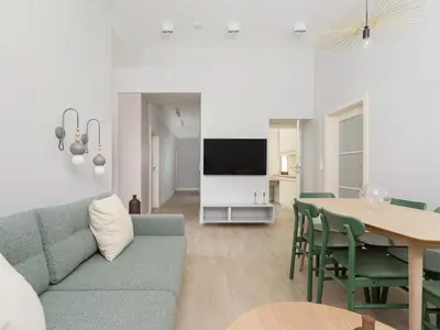 a living room with a blue couch and a table at 4 Bedroom Apartment - Main Square in Kraków