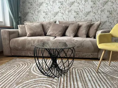 a living room with a couch and a glass table at Vintage Kalwaryjska Apartment in Kraków