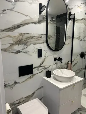 a bathroom with a white sink and a mirror at Vintage Kalwaryjska Apartment in Kraków