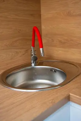 a kitchen sink with a red faucet at Apartament Słoneczny Rabka Zdrój in Rabka-Zdroj