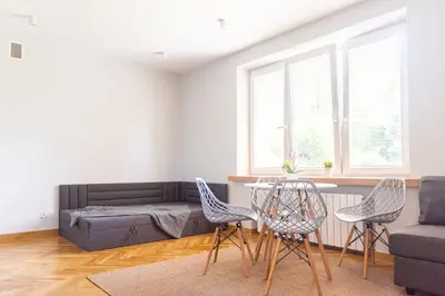 a living room with a couch and chairs and a table at Apartament Słoneczny Rabka Zdrój in Rabka-Zdroj