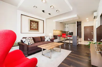 a living room with a couch and a table at Apartment with Private Parking - Lubicz 17 street in Kraków