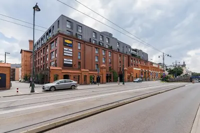 a car parked on a street in front of a building at Apartment with Private Parking - Lubicz 17 street in Kraków