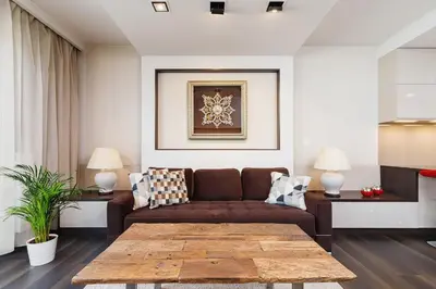 a living room with a couch and a table at Apartment with Private Parking - Lubicz 17 street in Kraków