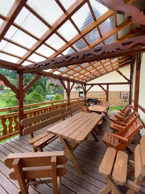 a group of picnic tables and benches on a deck at Jelonek Zawoja in Zawoja