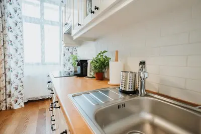 a kitchen with a stainless steel sink and a window at Sight Main Square & Main Train Station & Planty in Kraków