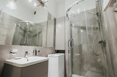 a bathroom with a shower and a toilet and a sink at Sight Main Square & Main Train Station & Planty in Kraków