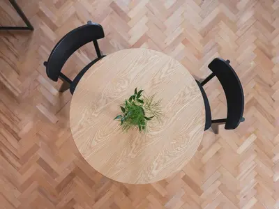 a table with a plant on top of a wooden floor at City center - Radziwiłłowska 27 in Kraków