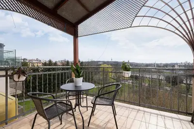 a patio with a table and chairs on a balcony at Apartment with terrace - Skawińska 20 in Kraków