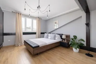 a bedroom with a bed and a large window at Apartment with terrace - Skawińska 20 in Kraków