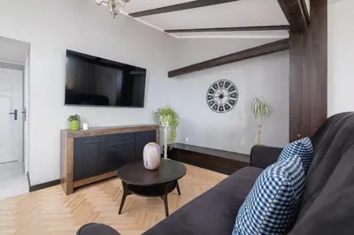 a living room with a couch and a table at Apartment with terrace - Skawińska 20 in Kraków