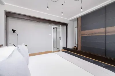 a bedroom with a large sliding glass door at Apartment with terrace - Skawińska 20 in Kraków