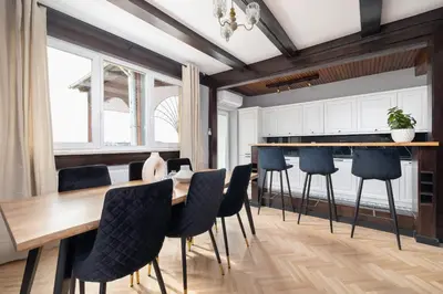 a dining room with a wooden table and chairs at Apartment with terrace - Skawińska 20 in Kraków