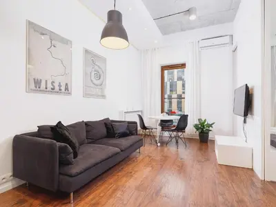 a living room with a couch and a table at Apartment with balcony - Pawia 34 Street in Kraków