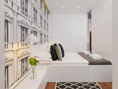 a room with a bed and a wall with buildings at Apartment with balcony - Pawia 34 Street in Kraków