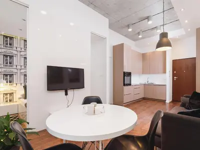 a living room with a white table and chairs at Apartment with balcony - Pawia 34 Street in Kraków