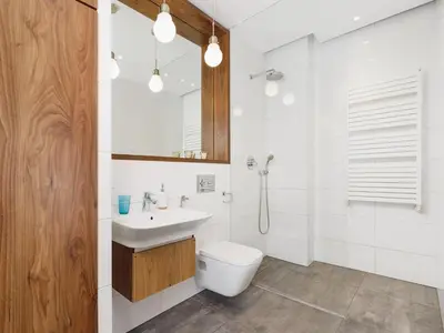 a white bathroom with a toilet and a sink at Apartment with balcony - Pawia 34 Street in Kraków