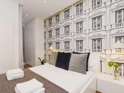 a bedroom with a white bed and a wall of windows at Apartment with balcony - Pawia 34 Street in Kraków