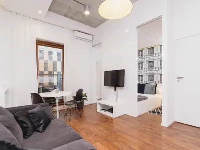 a living room with a couch and a bed and a table at Apartment with balcony - Pawia 34 Street in Kraków