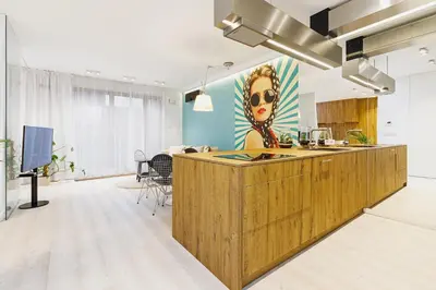 a kitchen with a wooden island in a room at Terrace Apartment - Lubicz 17 street in Kraków