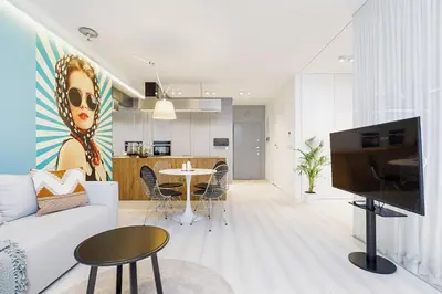 a living room with a white couch and a tv at Terrace Apartment - Lubicz 17 street in Kraków