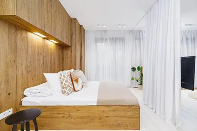 a bedroom with a large bed and a tv at Terrace Apartment - Lubicz 17 street in Kraków