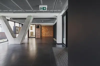 an empty hallway of a building with a sign on the ceiling at Terrace Apartment - Lubicz 17 street in Kraków