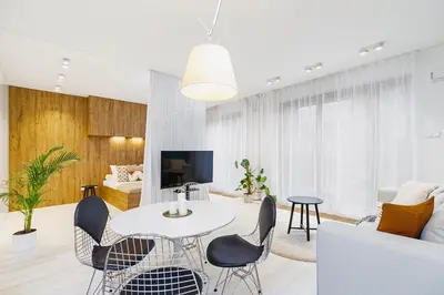a living room with a table and chairs at Terrace Apartment - Lubicz 17 street in Kraków
