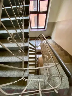 a spiral staircase in a building with a window at Starowiślna 66 in Kraków
