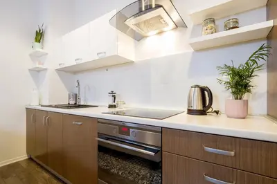 a kitchen with a sink and a stove at Main Station - 8 Rakowicka Street in Kraków