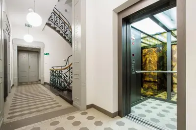 a hallway with a glass door and a staircase at Main Station - 8 Rakowicka Street in Kraków