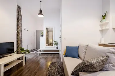 a living room with a couch and a tv at Main Station - 8 Rakowicka Street in Kraków